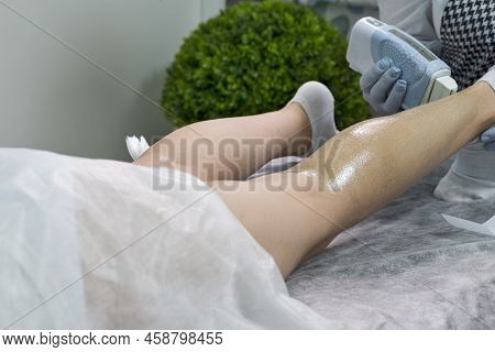 Using Hot Wax For Woman Leg In Spa. Closeup Of Body Hair Removal During Hair Removal Process On Cauc