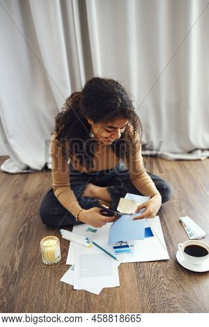 Young Brunette African American Woman Creating Her Feng Shui Wish Map Using Scissors. Dreams And Wis