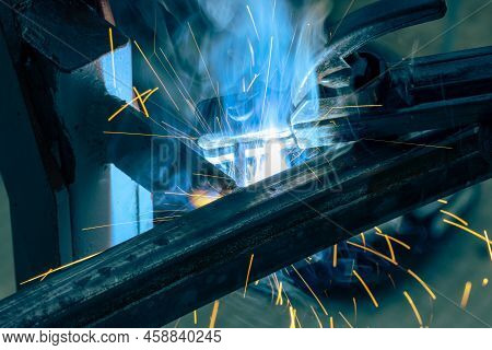 The Moment Of Welding With An Electrode, A Lot Of Sparks And Smoke, Welding Work