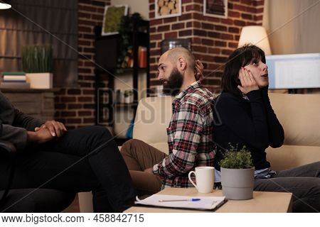 Married People Fighting At Couple Therapy Session With Counselor, Sitting Back Toback To Talk About 