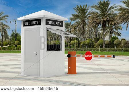 Road Car Barrier And Security Zone Booth With Security Sign In Empty City Street With Palm Trees Ext