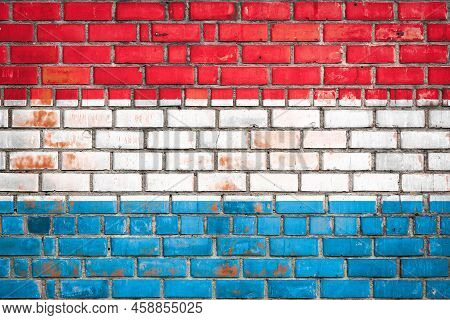 National  Flag Of The   Luxembourg  On A Grunge Brick Background.