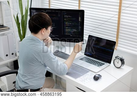 Professional development programmers are laying out a structure or draft on paper in preparation for