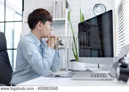 Professional development programmers are sit on a desk with work equipment such as: computer-laptop-