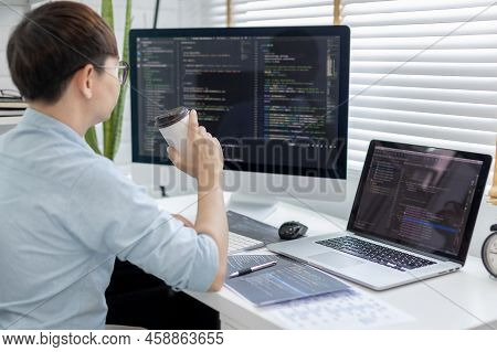 Professional development programmers are sipping coffee in a private office, Working on coding or pr