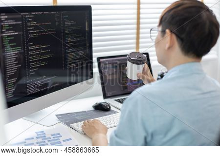 Professional development programmers are sipping coffee in a private office, Working on coding or pr