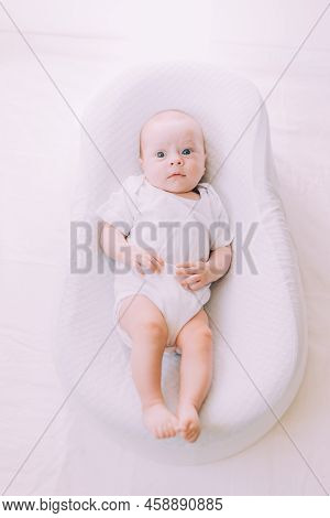 The Baby Is Lying In A Cocoon Of Copy Space . The Baby Is 0-3 Months Old. A Contented Infant. An Art