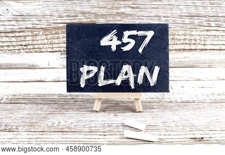 457 Plan Text On Miniature Chalkboard On Wooden Background