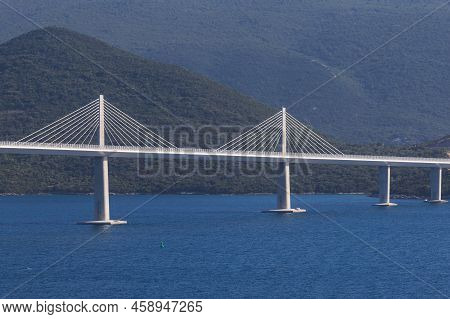 Beautiful Bridge Across The Sea To Peljesac Peninsula In Croatia. There Are Dramatic Clouds In The S