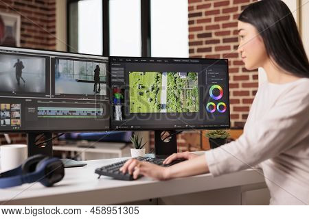 Asian Graphic Editor Working On Editing Video And Audio Footage With Professional Software To Create