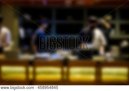 Blurred Image Of Chef In Open Kitchen In Japanese Resterant