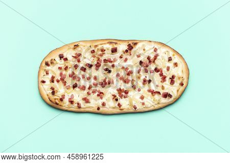 Top View With A Homemade Tarte Flambee Isolated On A Green-mint Background. Delicious Flammkuchen Wi