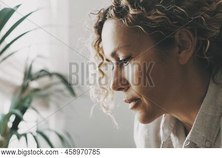 Close Up Portrait Of Woman With Worried Expression Looking Down. Beautiful Serene Female Face. Conce