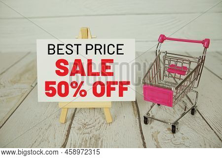 Best Price Sale 50% Off Text Message With Shoppint Trolley Cart On Wooden Background