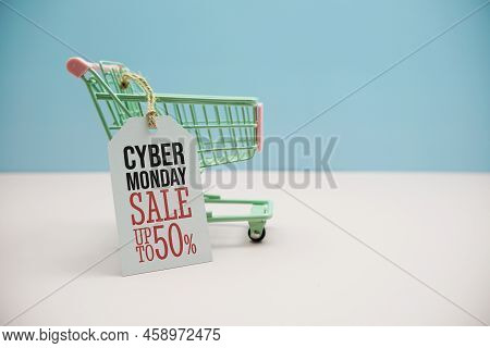 Cyber Monday Sale 50%  Text Message On Price Tax With Shoppint Trolley Cart On Blue Andp Pink Backgr