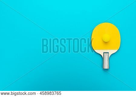 Racket And Ball For Table Tennis On Turquoise Blue Background. Flat Lay Image Of Table Tennis Paddle