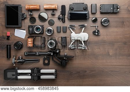 Short Movie Production Essentials On Wooden Background With Copy Space. Different Video Making Equip