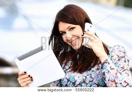 young businesswoman using digital tablet and mobile phone