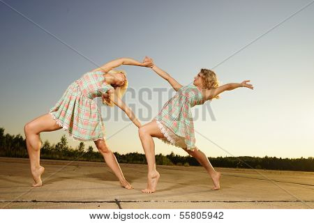 young women dancing on the road