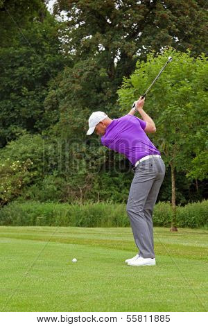 Photo of a golfer addressing the ball and playing a wedge shot into the green. Series of five in the set.