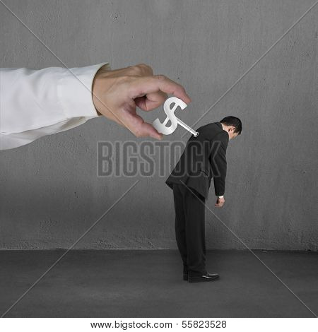 Hand Windering Winder On Businessman's Back, Concrete Background
