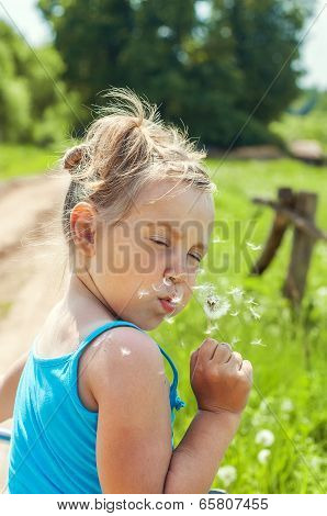 Little Girl Blowing Dandelion
