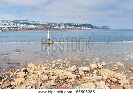 View from Shaldon to Teignmouth tourist town Devon England UK with rocks and clear sea