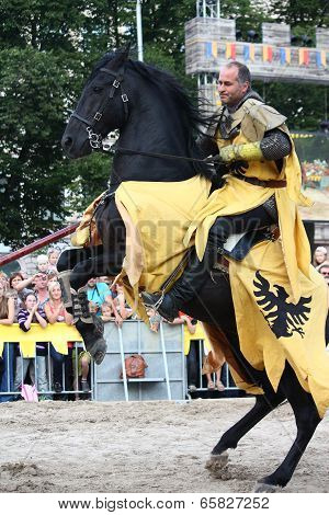 Riga, Latvia - August 21: Dan Naprous Member Of The Devils Horsemen Stunt Team Sitting On The Rearin