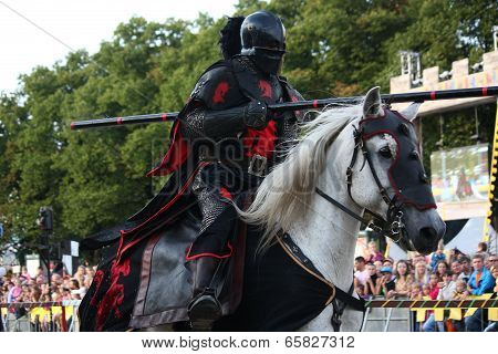Riga, Latvia - August 21: Gerard Naprous From The Devils Horsemen Stunt Team Riding White Horse Duri