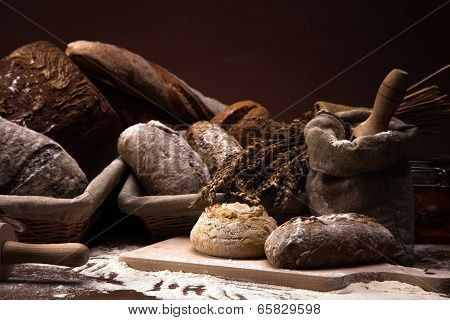 Fresh Bread And Wheat On The Wooden Table