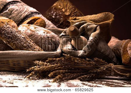 Fresh Bread And Wheat On The Wooden Table