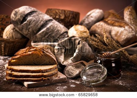 Fresh Bread And Wheat On The Wooden Table
