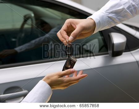 Woman Receiving Car Key From Man
