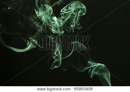 Green colored smoke on a black background.