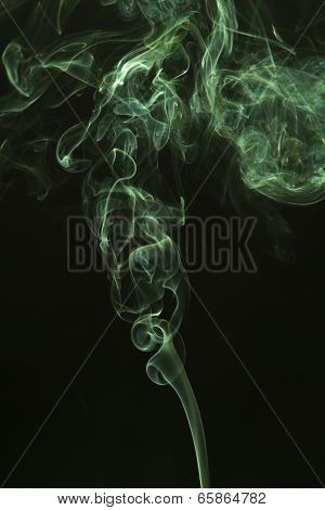 Green colored smoke on a black background.