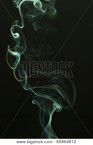 Green colored smoke on a black background.