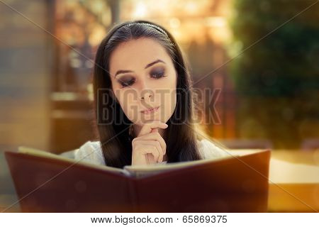 Young Woman Choosing from a Restaurant Menu