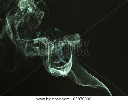 Green colored smoke on a black background.