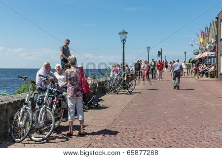 Tourists Visiting The Promenade Along The Sea Of Urk, The Netherlands