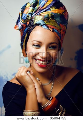 beauty bright african woman with creative make up, shawl on head like cubian woman