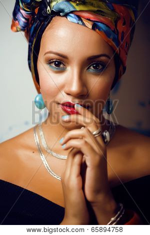 beauty bright african woman with creative make up, shawl on head like cubian woman