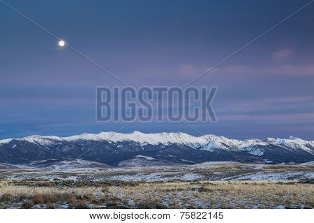 full moon over snowy Medicine Bow Mountains, North Park near Walden, Colorado