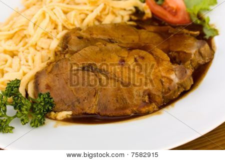 Roast of Pork with Sauce,and spaetzle , type of South German pasta dish