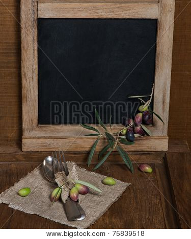 Rustic Table Setting With Olive Decor On Old Wooden Table