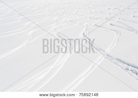 Skiing, snow, freeski - freeride tracks on powder snow
