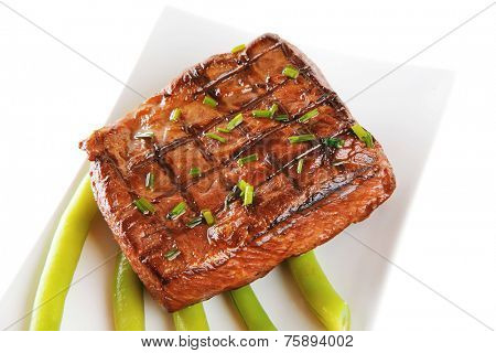 beef meat served with tomato on white porcelain