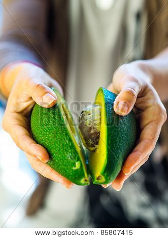 avocado in a hand of woman