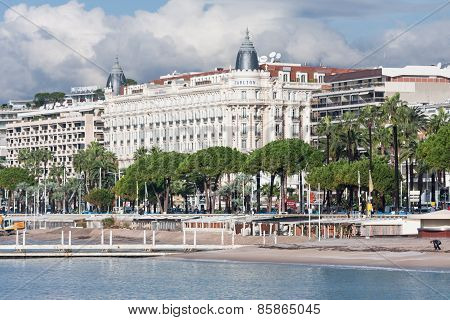 Promenade Cannes With Unknown People And A Frontview Of The Famous Carlton Hotel At Cannes, France