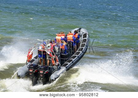 USTKA - JULY 07: Tourists enjoy a high speed boat ride on the Baltic sea near the harbour on 7 July 2015 in Ustka, Poland.