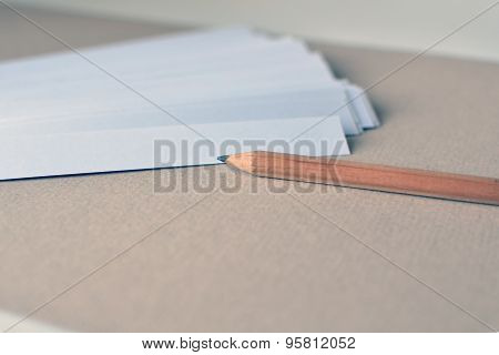 Paper stripes for notes with pencil on a paper beige background